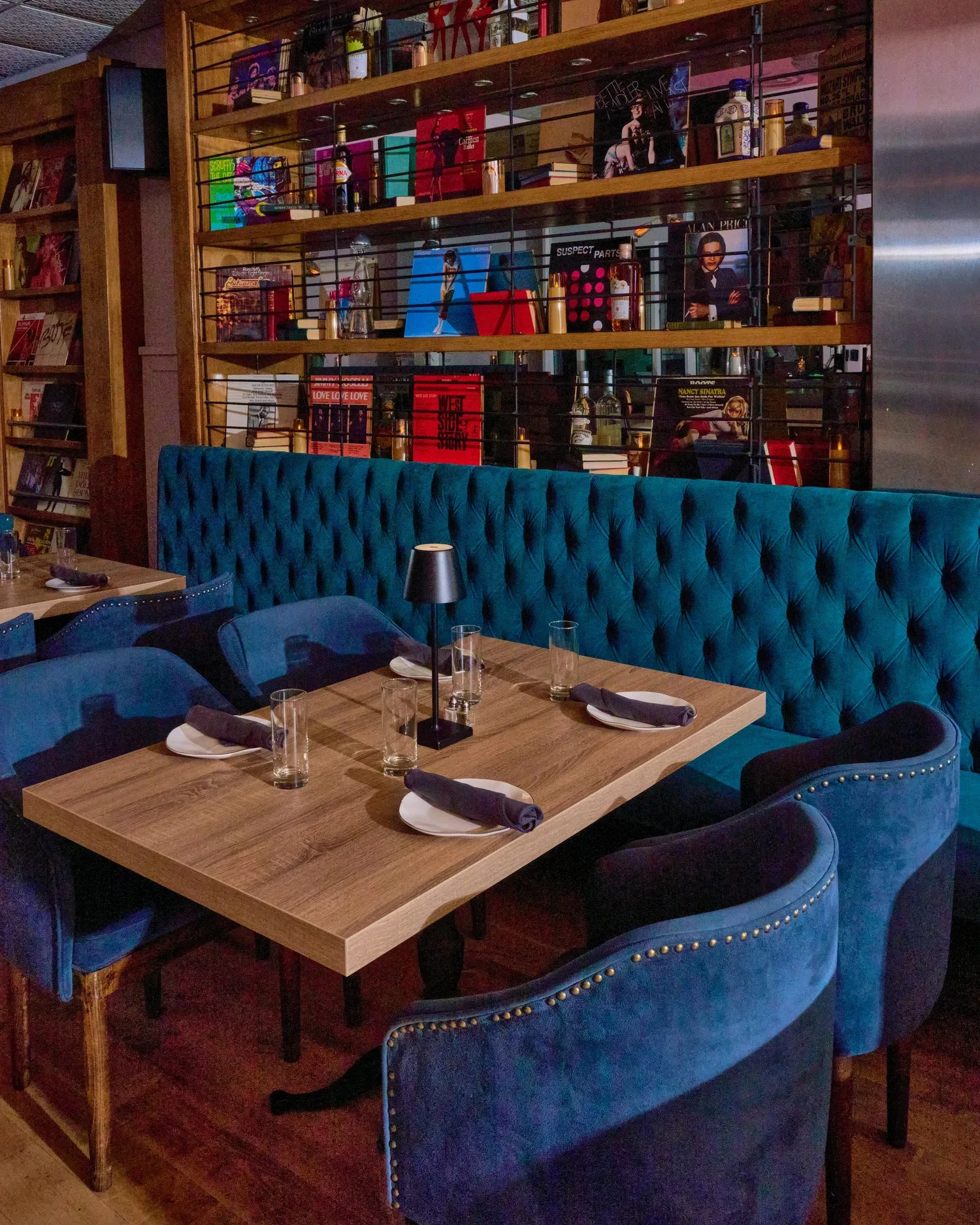 Rosetta's teal banquette, dining tables, and wall of records